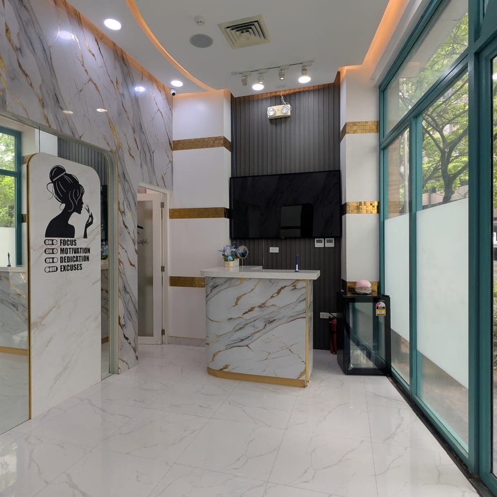 The Better Face reception: a marble front desk, white tiled floor and tall glass windows onto the street